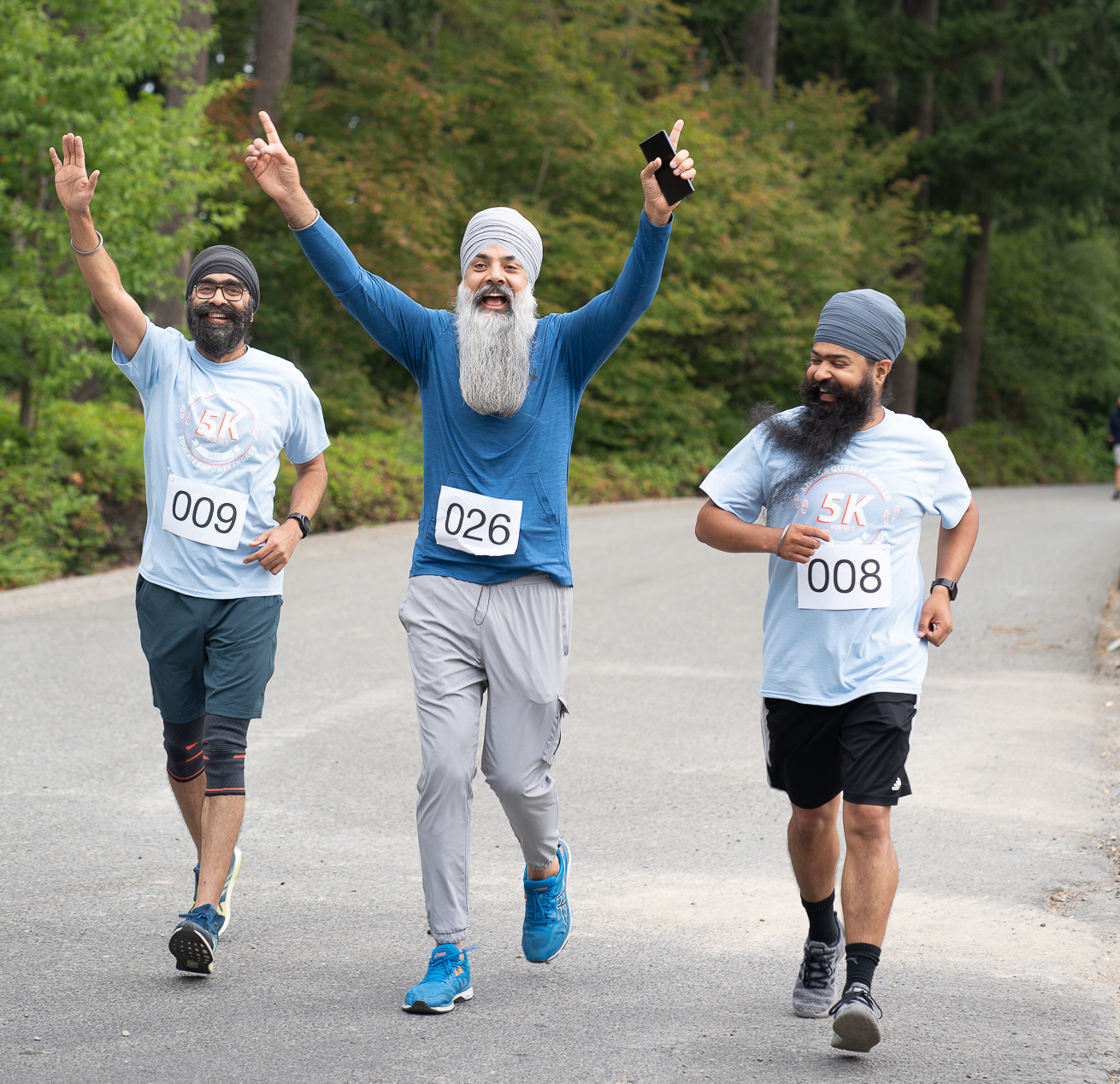 Image of runners cheering as they run the 5k race